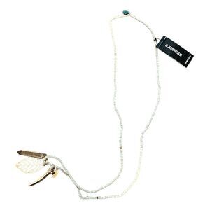Express white beaded necklace with gold tone pendants. NWT